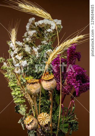 Rustic Dried Flower and Wheat Bouquet on Brown Backdrop Rustic Dried Flower and Wheat Bouquet on Brown Backdrop 129684685