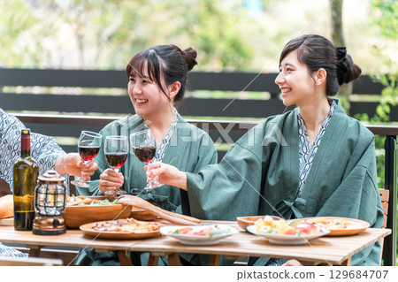 Young men and women visiting a ryokan or hot spring inn (company trip, travel) 129684707