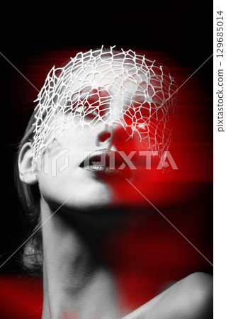 Beautiful woman with fancy make-up and abstract face mask studio portrait in RGB color split effect style Beautiful woman with fancy make-up and abstract face mask studio portrait in RGB color split effect style 129685014