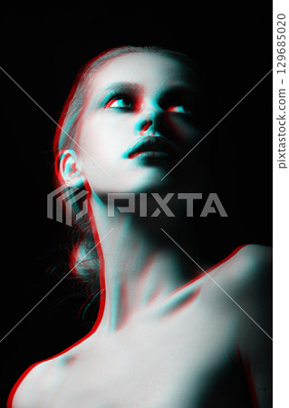 Beautiful woman with fancy make-up close-up studio portrait in RGB color split effect style 129685020