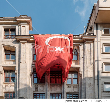 Large Turkish flag draped over a historic building facade in Istanbul, Turkey Large Turkish flag draped over a historic building facade in Istanbul, Turkey 129685106