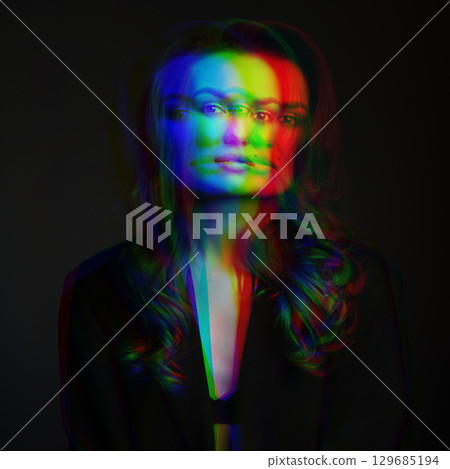 Beautiful woman with dark suit and wavy hair studio portrait in RGB color split effect style 129685194