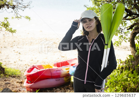 Cute woman enjoying kayaking 129685637