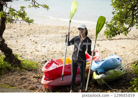 Cute woman enjoying kayaking Cute woman enjoying kayaking 129685859