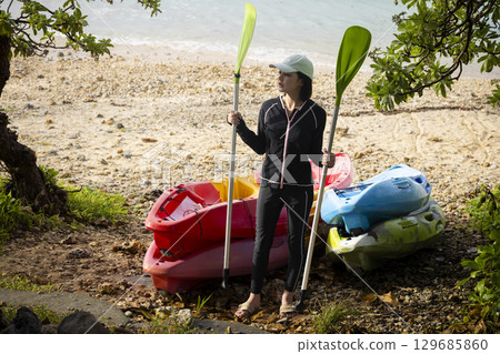 Cute woman enjoying kayaking Cute woman enjoying kayaking 129685860