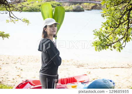Cute woman enjoying kayaking Cute woman enjoying kayaking 129685935