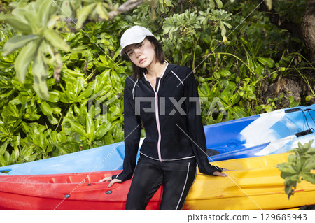 Cute woman enjoying kayaking 129685943