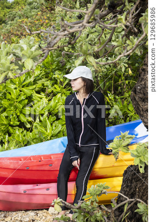 Cute woman enjoying kayaking Cute woman enjoying kayaking 129685986
