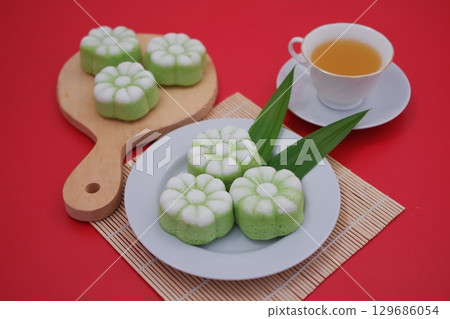 Traditional Indonesian Pandan Cake with Cup of Tea 129686054