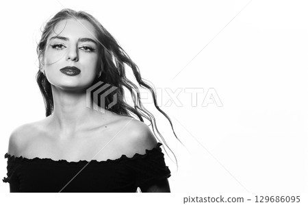Beautiful woman with long wavy flying hair sensual studio portrait 129686095