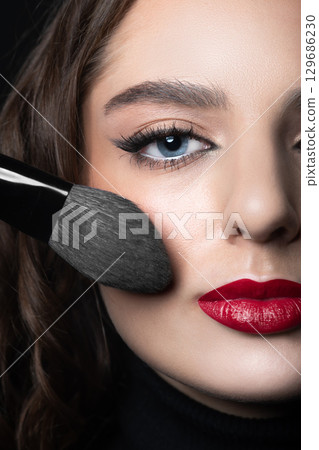 Beautiful woman with make-up and red lips studio portrait Beautiful woman with make-up and red lips studio portrait 129686230