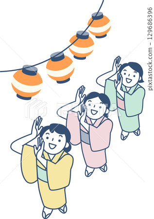 Women in yukata dancing at the Bon Odori festival 129686396