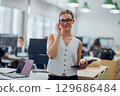 A Professional Woman Working in a Contemporary Office Environment, Engaging with Others 129686484