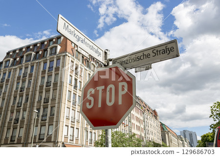 Berlin, Germany - July 01, 2018: STOP road sign and direction signs of street names in Berlin 129686703