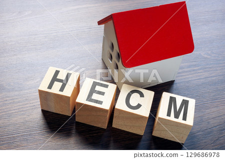 House model and HECM home equity conversion mortgage. House model and HECM home equity conversion mortgage. 129686978