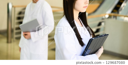 Portrait of a person wearing a white coat 129687080