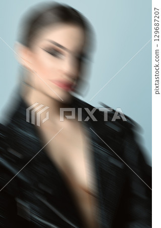 Woman studio portrait with black punk leather jacket and without bra in motion blur style Woman studio portrait with black punk leather jacket and without bra in motion blur style 129687207