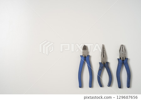 Pliers and nippers lined up on a white background Pliers and nippers lined up on a white background 129687656