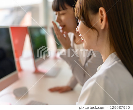 A woman in a white coat and a woman in a jacket 129687930