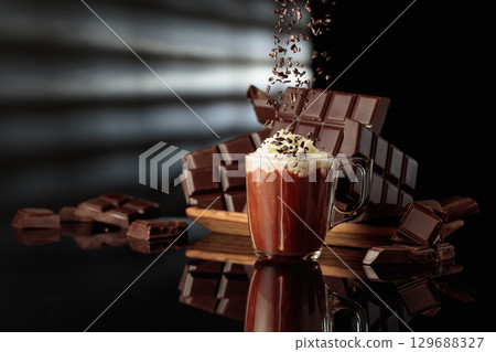 Hot chocolate with whipped cream sprinkled with chocolate crumb. 129688327
