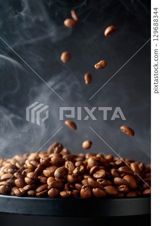 Steaming coffee beans in movement. Steaming coffee beans in movement. 129688344