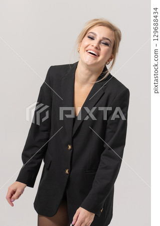 Beautiful woman with black suit studio portrait portrait on white background 129688434