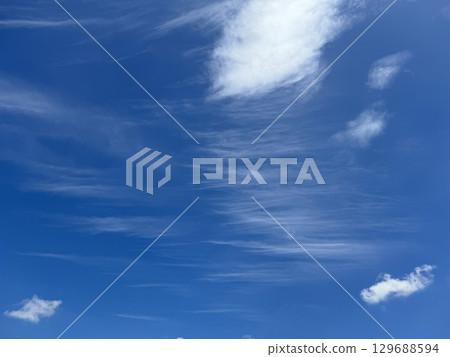 Blue sky and flowing streaky clouds Blue sky and flowing streaky clouds 129688594