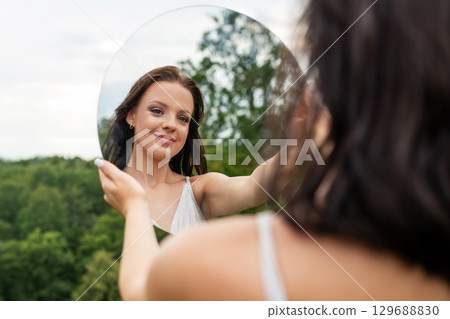 Woman Reflecting in Nature Woman Reflecting in Nature 129688830