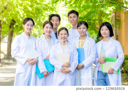 Medical school students wearing white coats Medical school students wearing white coats 129688926