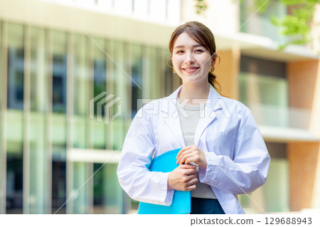 Female student in white coat 129688943