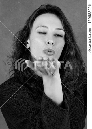 Woman sending air kiss 129688996