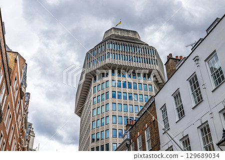 Corporate Building Rising Over Central London Streets, Overcast Sky and Geometric Facade Corporate Building Rising Over Central London Streets, Overcast Sky and Geometric Facade 129689034