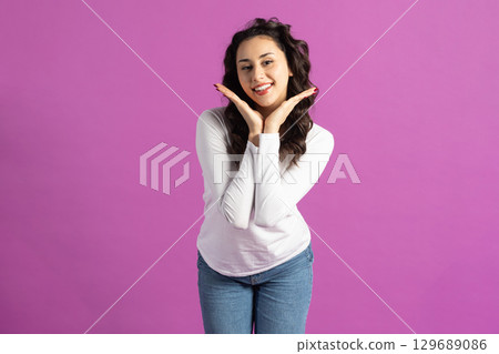 Beautiful woman with her hands palms near face 129689086