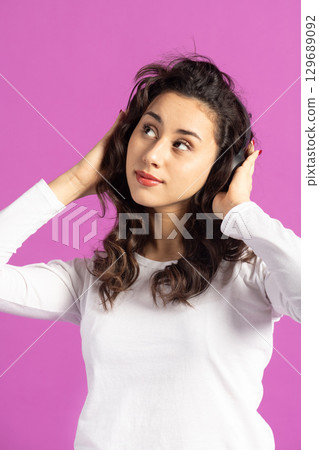 Beautiful woman listening music with headphones 129689092