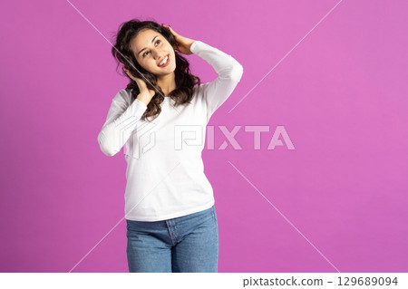 Beautiful woman listening music with headphones 129689094