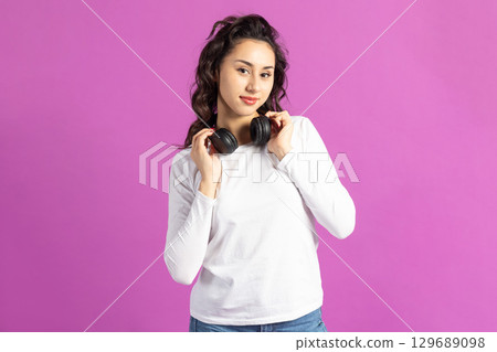 Beautiful woman listening music with headphones 129689098