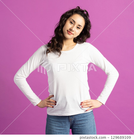 Beautiful woman studio portrait against purple background 129689109