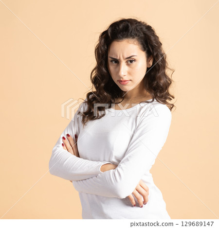 Serious woman portrait with crossed arms Serious woman portrait with crossed arms 129689147