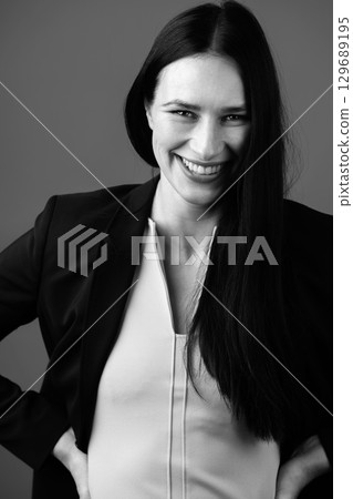 Beautiful woman with dark hair and classic outfit studio portrait 129689195