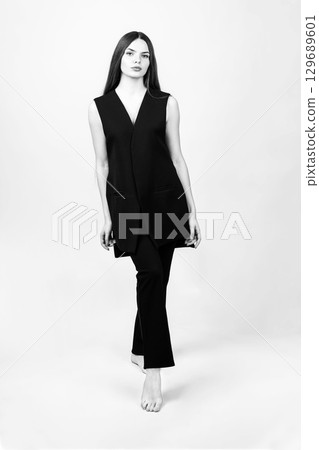 Beautiful woman with black suit studio portrait 129689601