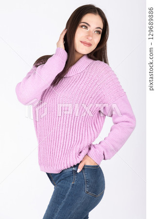 Beautiful woman with pink sweater and blue jeans portrait 129689886
