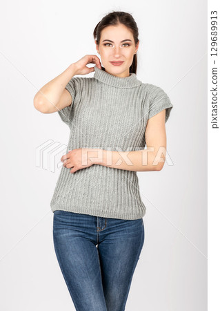 Close-up shot of woman wearing gray sweater without sleeves Close-up shot of woman wearing gray sweater without sleeves 129689913
