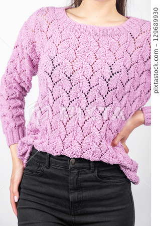Beautiful woman with pink sweater and black jeans portrait 129689930