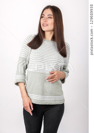 Beautiful woman studio portrait wearing bright sweater with pattern 129689938