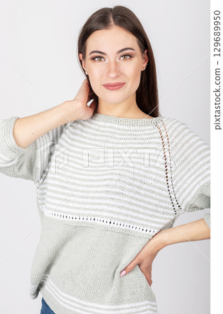 Beautiful woman studio portrait wearing bright sweater Beautiful woman studio portrait wearing bright sweater 129689950