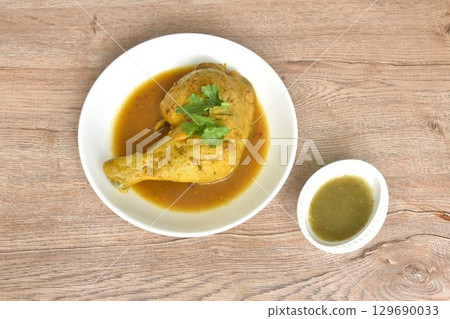 baking chicken tight and leg with herb on plate dipping spicy and sour chili sauce in cup baking chicken tight and leg with herb on plate dipping spicy and sour chili sauce in cup 129690033