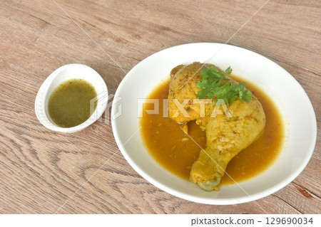 baking chicken tight and leg with herb on plate dipping spicy and sour chili sauce in cup baking chicken tight and leg with herb on plate dipping spicy and sour chili sauce in cup 129690034