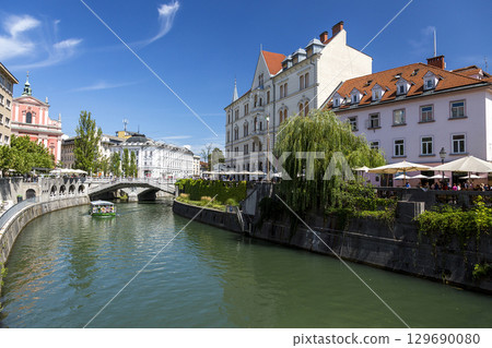 Ljubljana, Slovenia - August 15, 2019: View of the embankment of the Ljubljana River in Ljubljana Ljubljana, Slovenia - August 15, 2019: View of the embankment of the Ljubljana River in Ljubljana 129690080