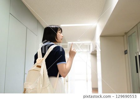 A woman walking inside the facility A woman walking inside the facility 129690553