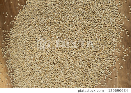 Uncooked White Quinoa Close-Up. Natural Grain Pattern. 129690684